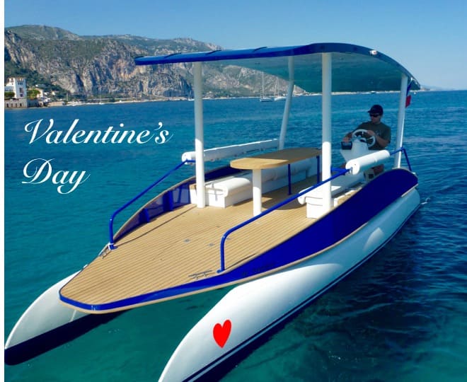 Catamaran with blue canopy and heart design on water, text 'Valentine's Day' on left.