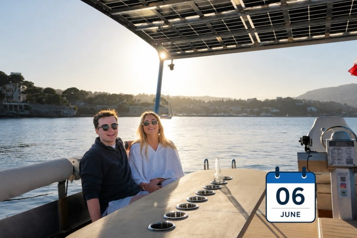 Two people on a boat at sunset with a calendar showing June 6.